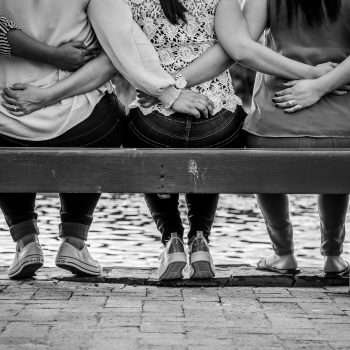 Women supporting women with arms around each others' backs