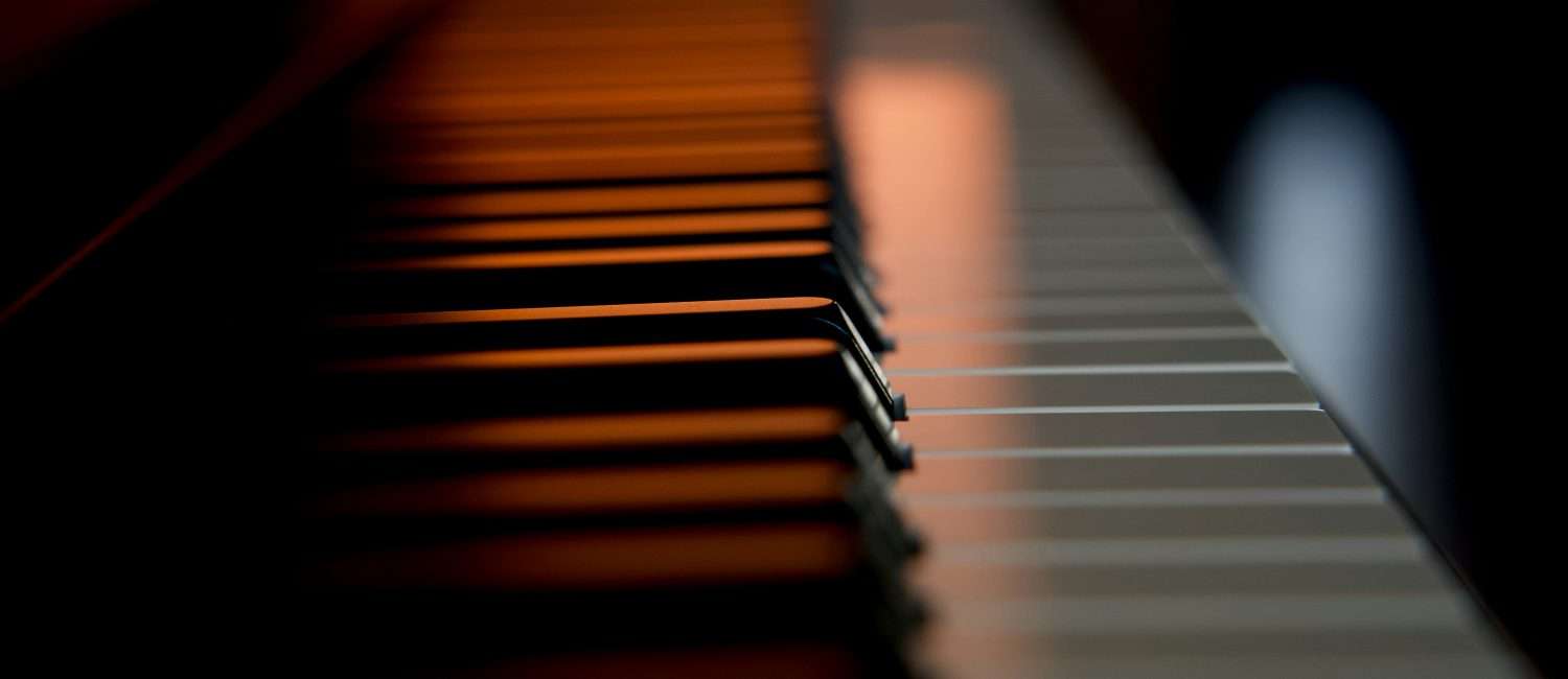 Piano keys illuminated by a soft light