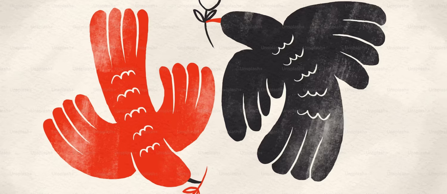 Two birds, one red and one black, carrying flowers - Photo by HJ Project Photo